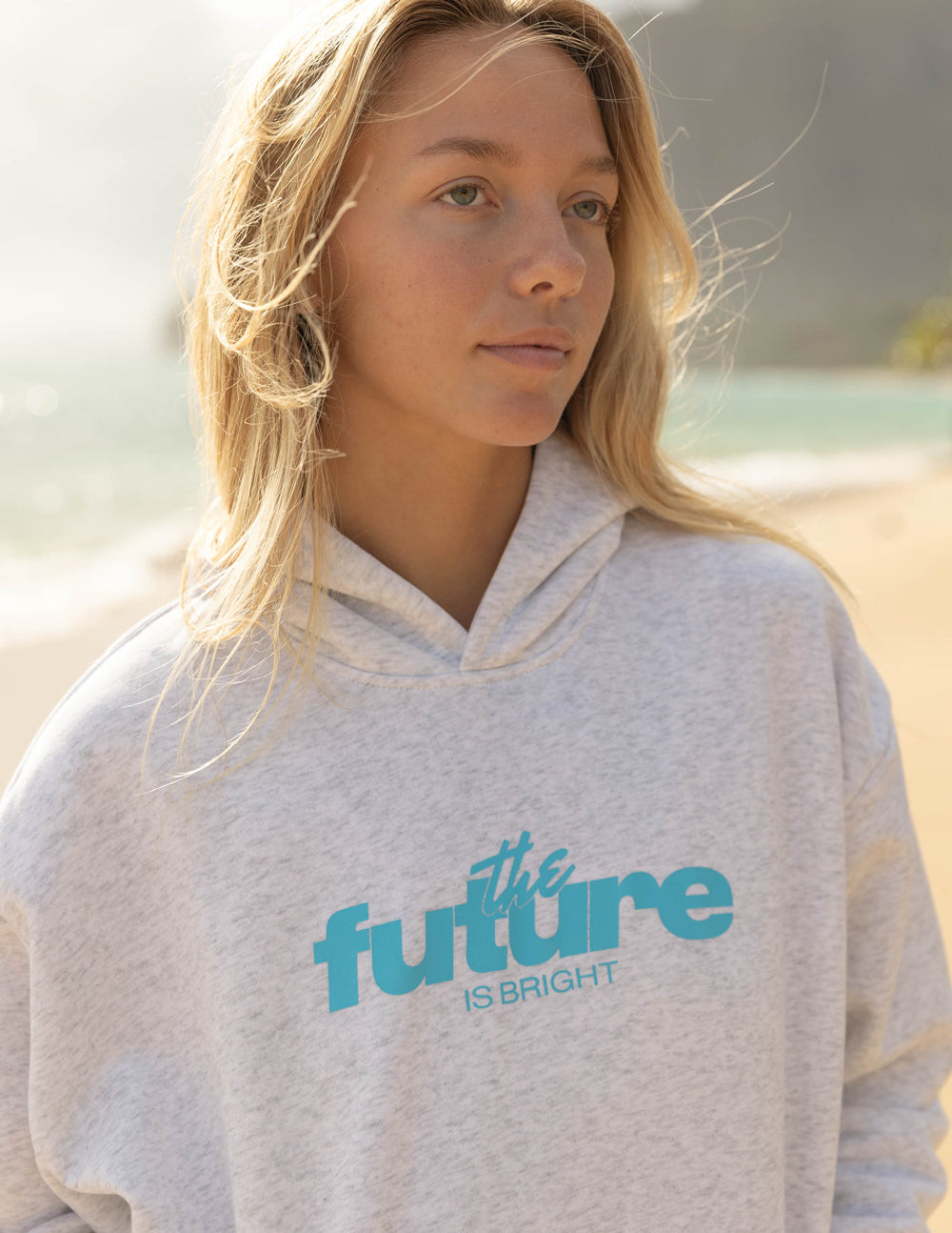 Person wearing a hoodie with 'the future is bright' text