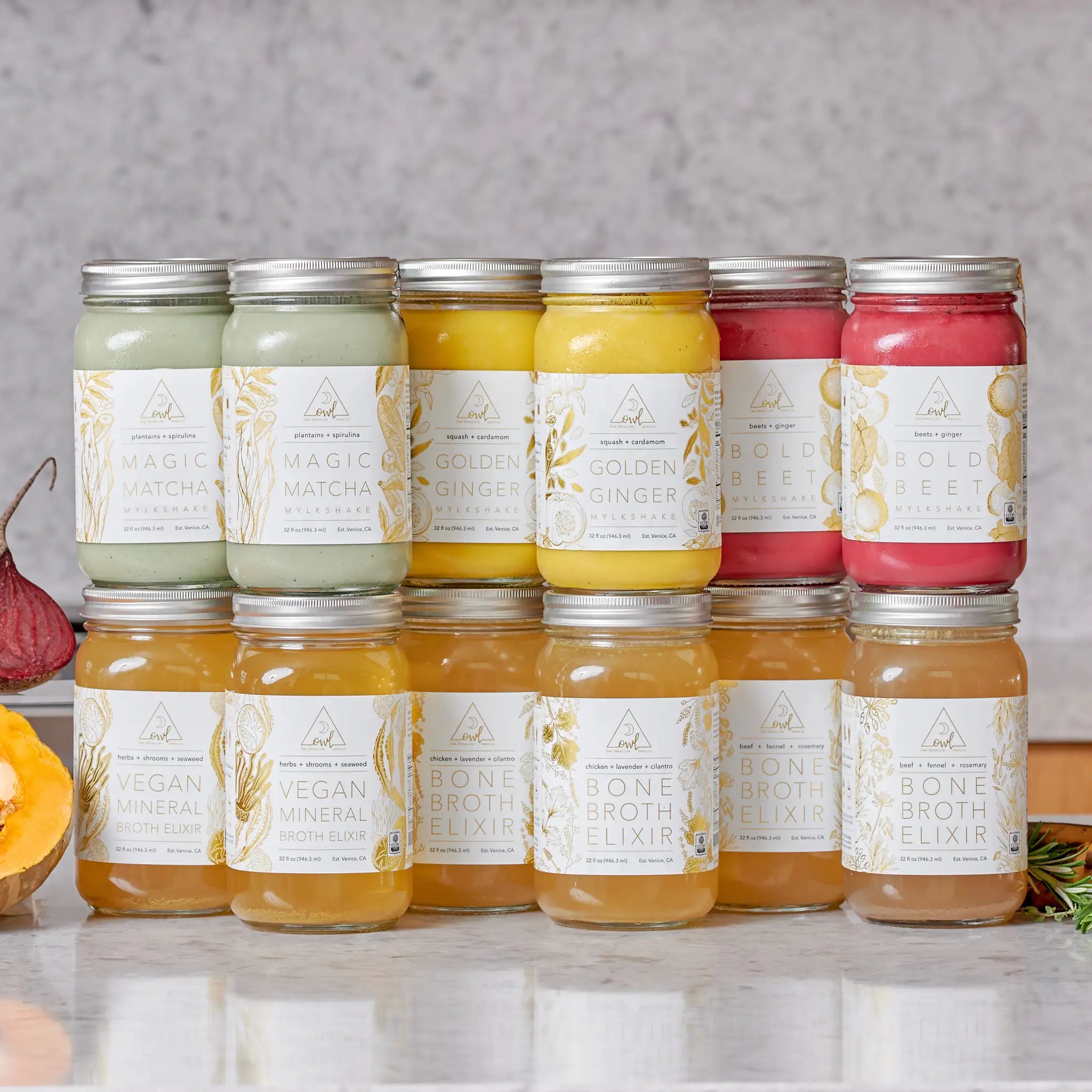 Row of OWL Reset organic cleanse jars featuring Bone Broth Elixirs and Mylkshake flavors on a neutral background. The OWL Reset - Organic Cleanse Program with 6 Broth Elixirs, 6 Mylkshake Packets (2 Magic Matcha, 2 Golden Ginger, and 2 Bold Beet)