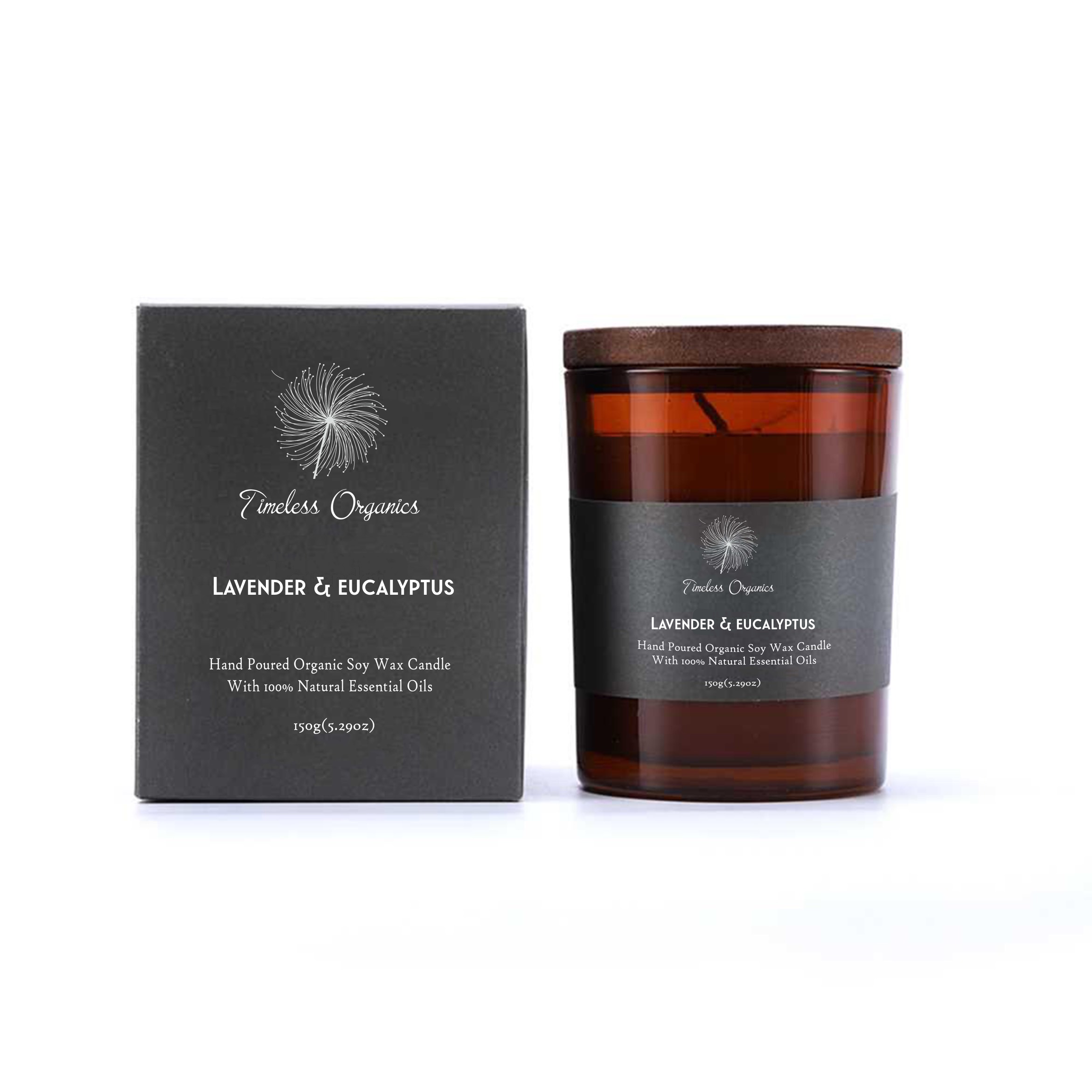 Candle and packaging with 'Timeless Organics' branding on a white background. Hand-poured Timeless Organics Lavender & Eucalyptus organic soy wax candle in an amber glass jar with matching gift box, infused with 100% natural essential oils for a clean-burning home fragrance.