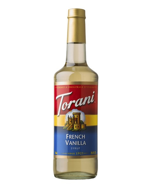 A bottle of Torani French Vanilla Syrup on a plain white background. The bottle is made of clear glass showing the pale yellow liquid inside, topped with a gold cap. 750 mL