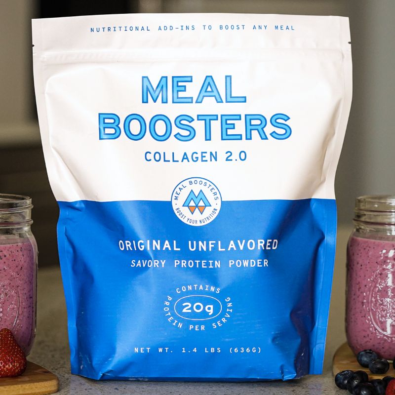 Original Unflavored Grass-Fed Collagen protein powder in a resealable blue and white pouch with 20g protein per serving, displayed beside berry smoothies on a kitchen countertop.