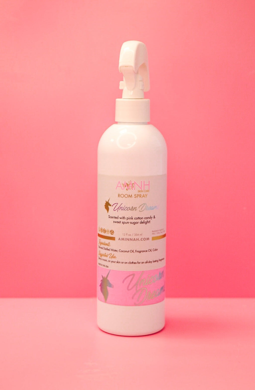 Unicorn Dreams Room Spray by AMINNAH on a soft pink background, featuring a whimsical unicorn-themed room spray made with natural ingredients. This clean beauty home fragrance is vegan, cruelty-free, paraben-free, and gluten-free, packaged in a recyclable bottle by a female-owned brand for a fresh, inviting scent and eco-conscious lifestyle.