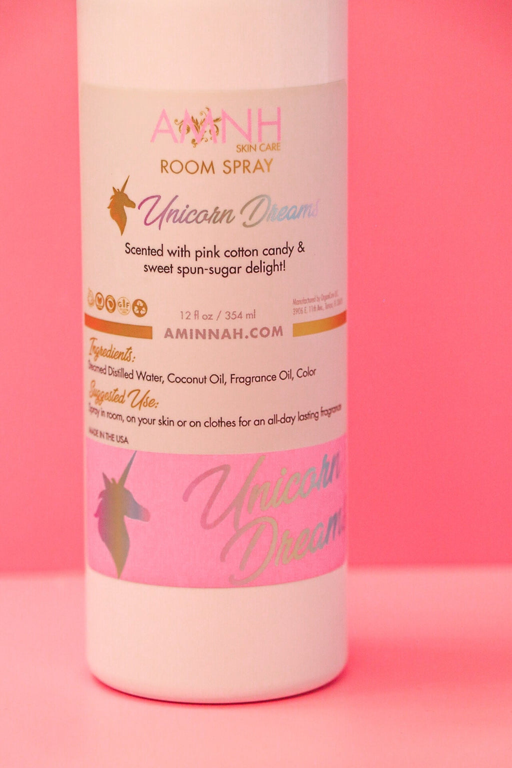 Unicorn Dreams Room Spray by AMINNAH on a soft pink background, featuring a whimsical home fragrance crafted with natural ingredients. This clean beauty room spray is vegan, cruelty-free, paraben-free, and gluten-free, packaged in recyclable packaging by a female-owned brand for a fresh, sweet cotton candy-inspired scent that helps create a welcoming atmosphere.