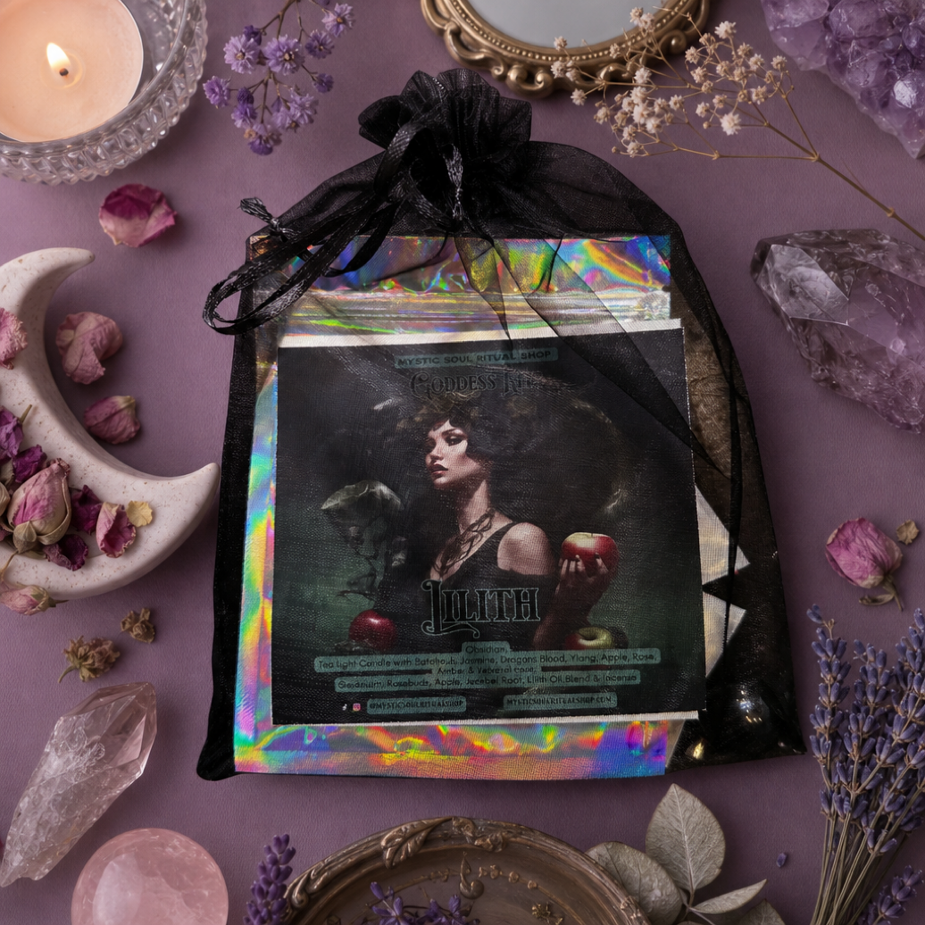 A black sheer drawstring pouch containing a tarot deck with an iridescent holographic border and a central card featuring a dark gothic portrait, styled on a purple surface with crystals, dried flowers, a candle, and decorative props.  A part pf Lilith Devotional Goddess Kit with orris root, rosebuds, incense sticks and oil for evoking Lilith: Goddess of independence, sexuality, feminine sovereignty, and righteous rage. Dark feminine occult work.