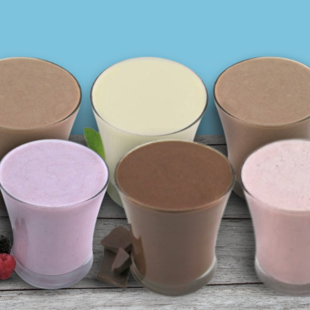 Six glasses of different colored shakes on a wooden surface with a blue background