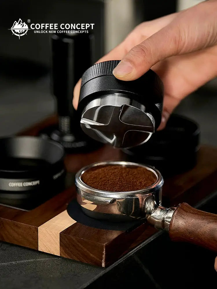 COFFEECONCEPT stainless steel gravity espresso distributor leveling freshly ground coffee in a portafilter for even extraction and professional espresso preparation