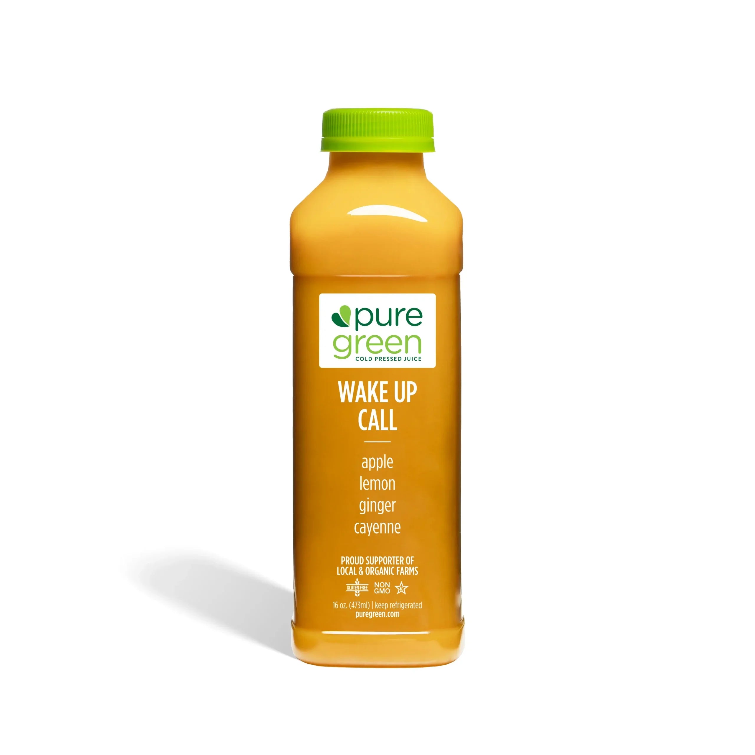 Orange juice bottle labeled 'pure green Wake Up Call' on a white background. Cold-Pressed NON-GMO Juice Drink with Apple, Lemon, Ginger and Cayenne, No Added Sugar, Gluten-Free