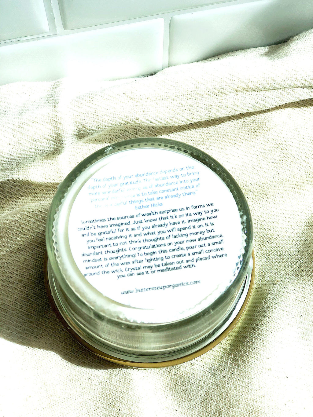 Jar lid with text on a light fabric background
