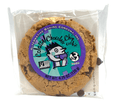 Colossal vegan chocolate chip cookie in clear wrapper with a purple and teal Alternative Baking Company label on a white background.