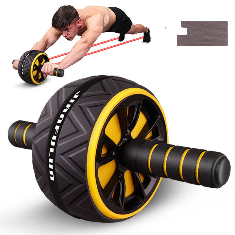 An abdominal exercise wheel with a black and yellow design, shown in the foreground with a man performing a push-up using a red resistance band in the background. A small inset shows a close-up of the wheel's textured surface.