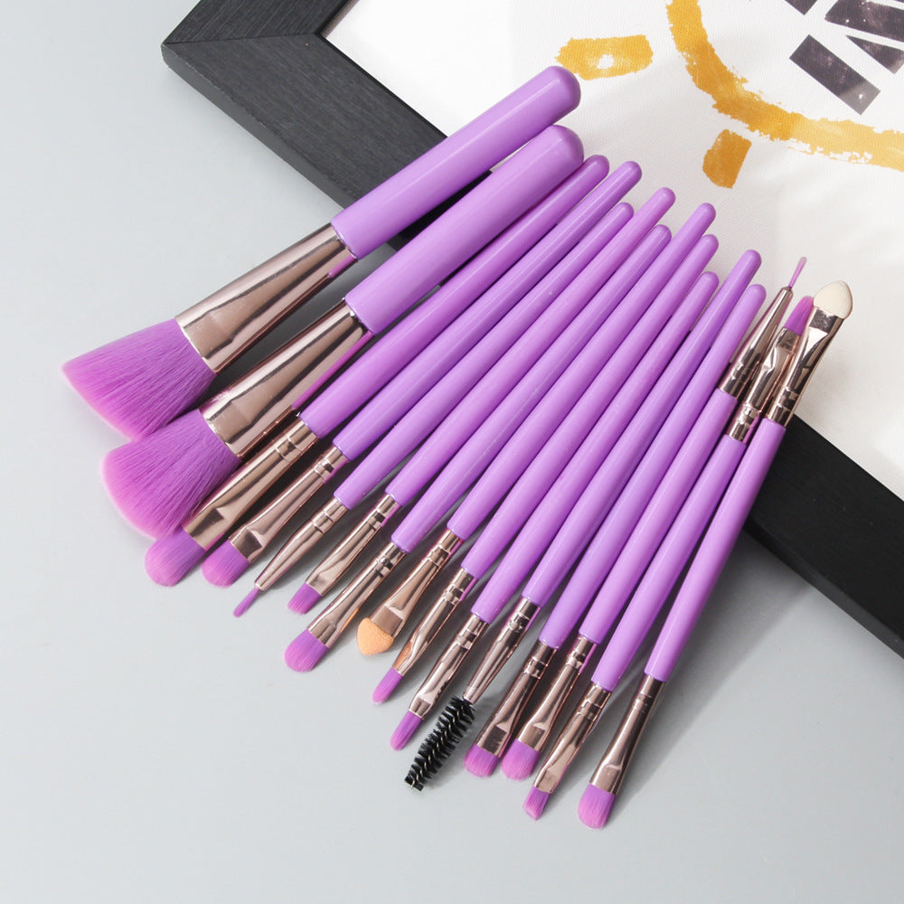 Set of makeup brushes with purple handles and bristles on a light gray background