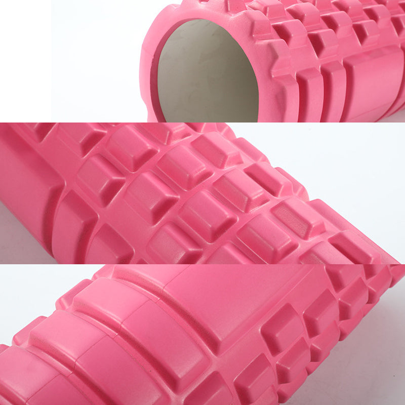 Close-up of a pink foam roller with textured surface on a white background