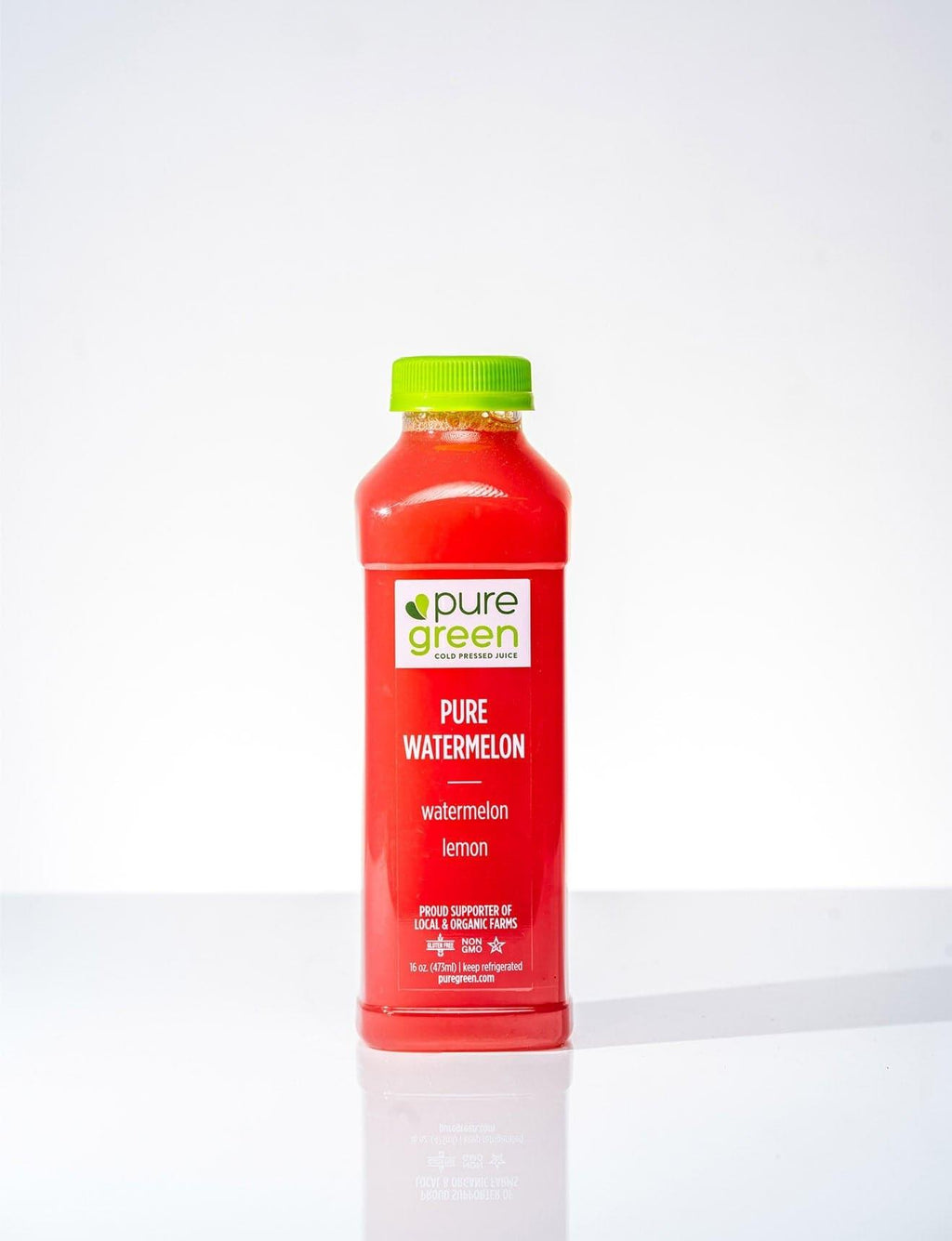 Red bottle of pure green pure watermelon juice with a green cap on a white background. PURE GREEN PURE WATERMELON Cold-Pressed NON-GMO Juice Drink with Lemon, No Added Sugar, Gluten-Free Two ingredient only drink. No Added Sugars, Gluten-Free Juice Drink.