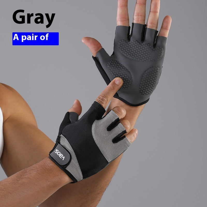 Gray half-finger gloves being worn on a person's hand against a gray background