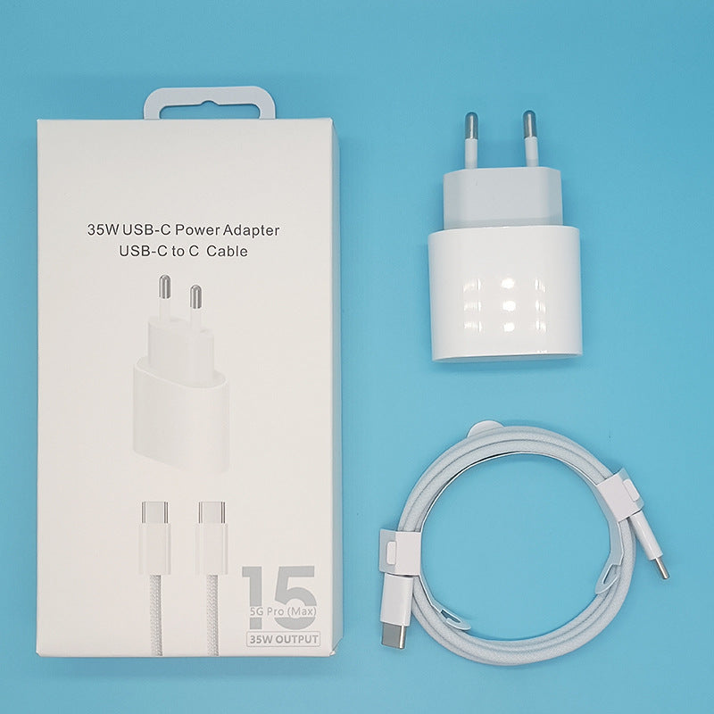A 35W USB-C power adapter and USB-C to C cable set displayed next to its white retail packaging box on a solid light blue background.