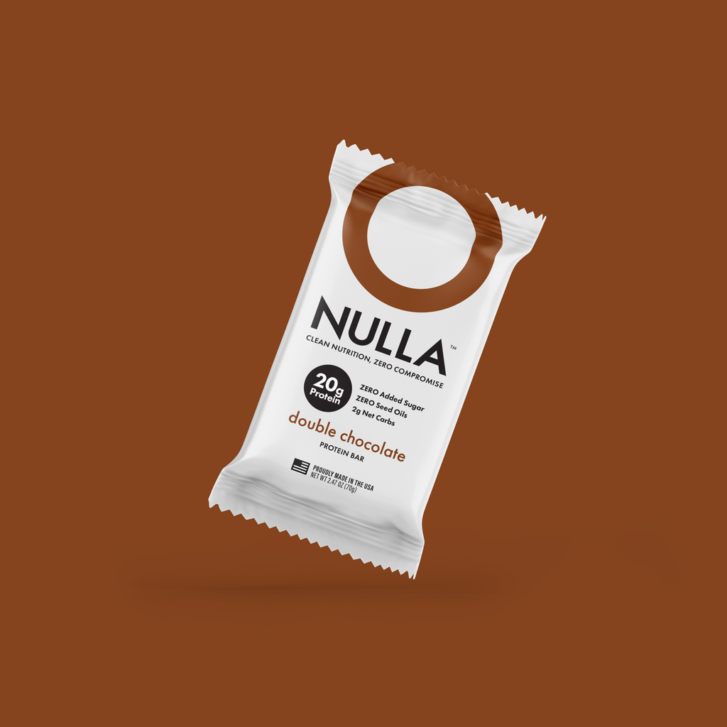 NULLA double chocolate protein bar packaging on a brown background