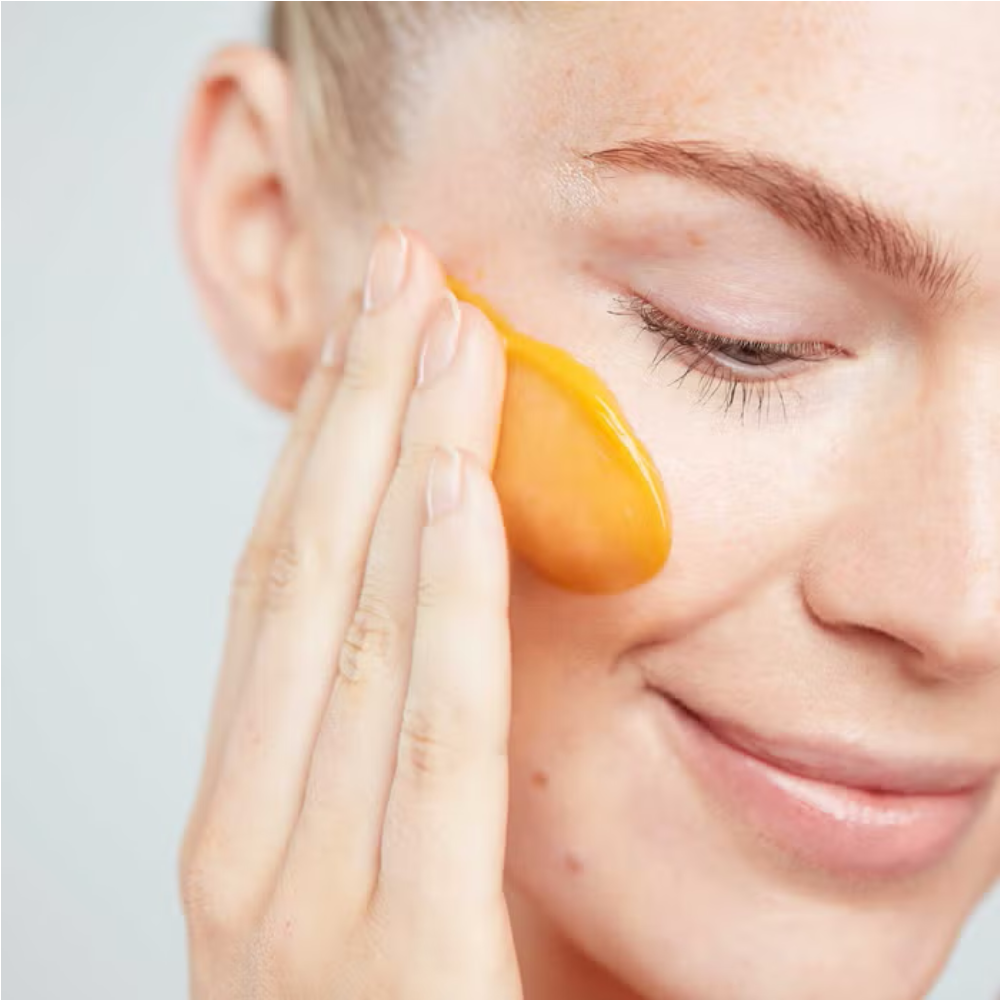 Woman applying ELEMIS Superfood Glow Cleansing Butter to face for gentle makeup removal, deep cleansing and radiant-looking skin