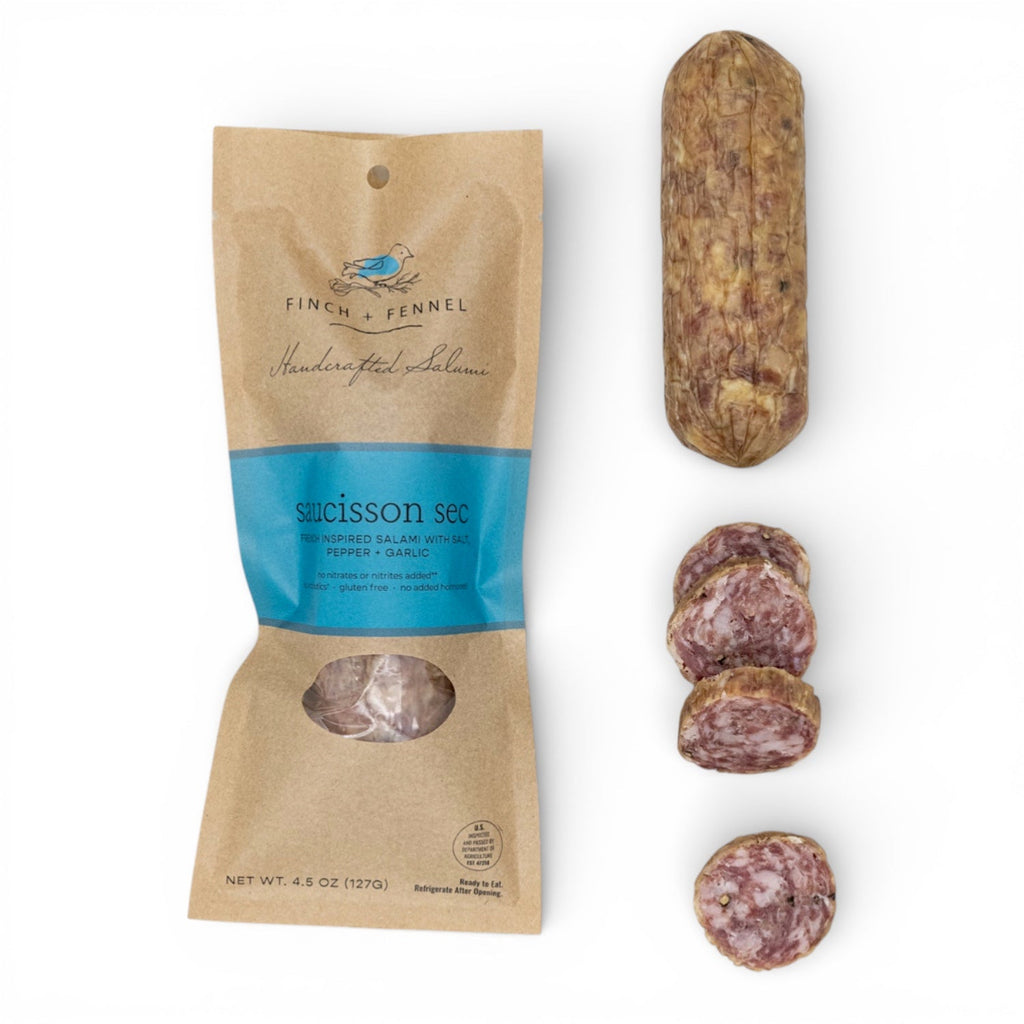 Packaged salami with sliced pieces on a white background French Saucisson Sec Salumi | Finch + Fennel