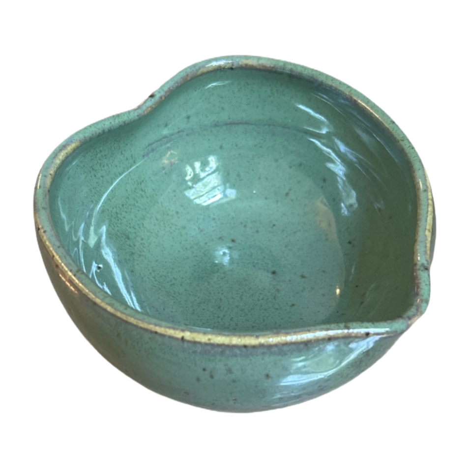 Green ceramic bowl on a white background