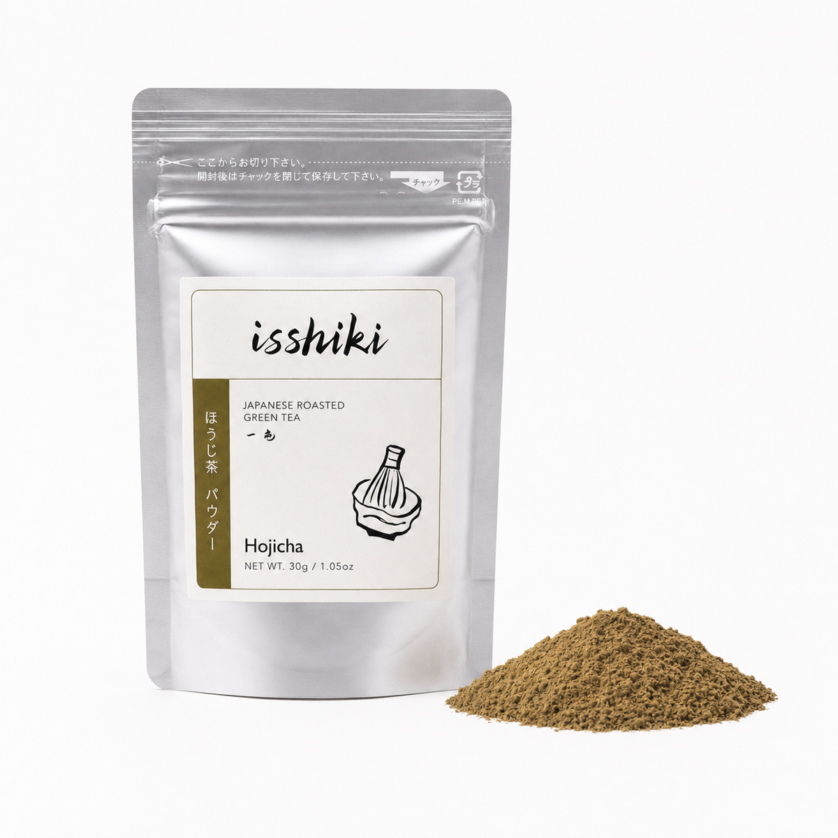 A silver stand-up pouch of isshiki Japanese Roasted Green Tea (Hojicha) powder with a small pile of the brown tea powder next to it on a white background.
