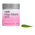 A silver metal tin of Isshiki Ichigo Matcha with a pink gradient label, shown on a white background with a small green powder smear to the right.