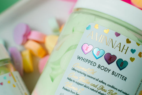 AMINNAH XOXO Whipped Body Butter with shea butter, cocoa butter, mango butter, coconut oil, jojoba oil, vitamin E, and fruit extracts. Sweet candy-scented vegan, cruelty-free clean beauty moisturizer from a female-owned brand for soft, hydrated, glowing skin.