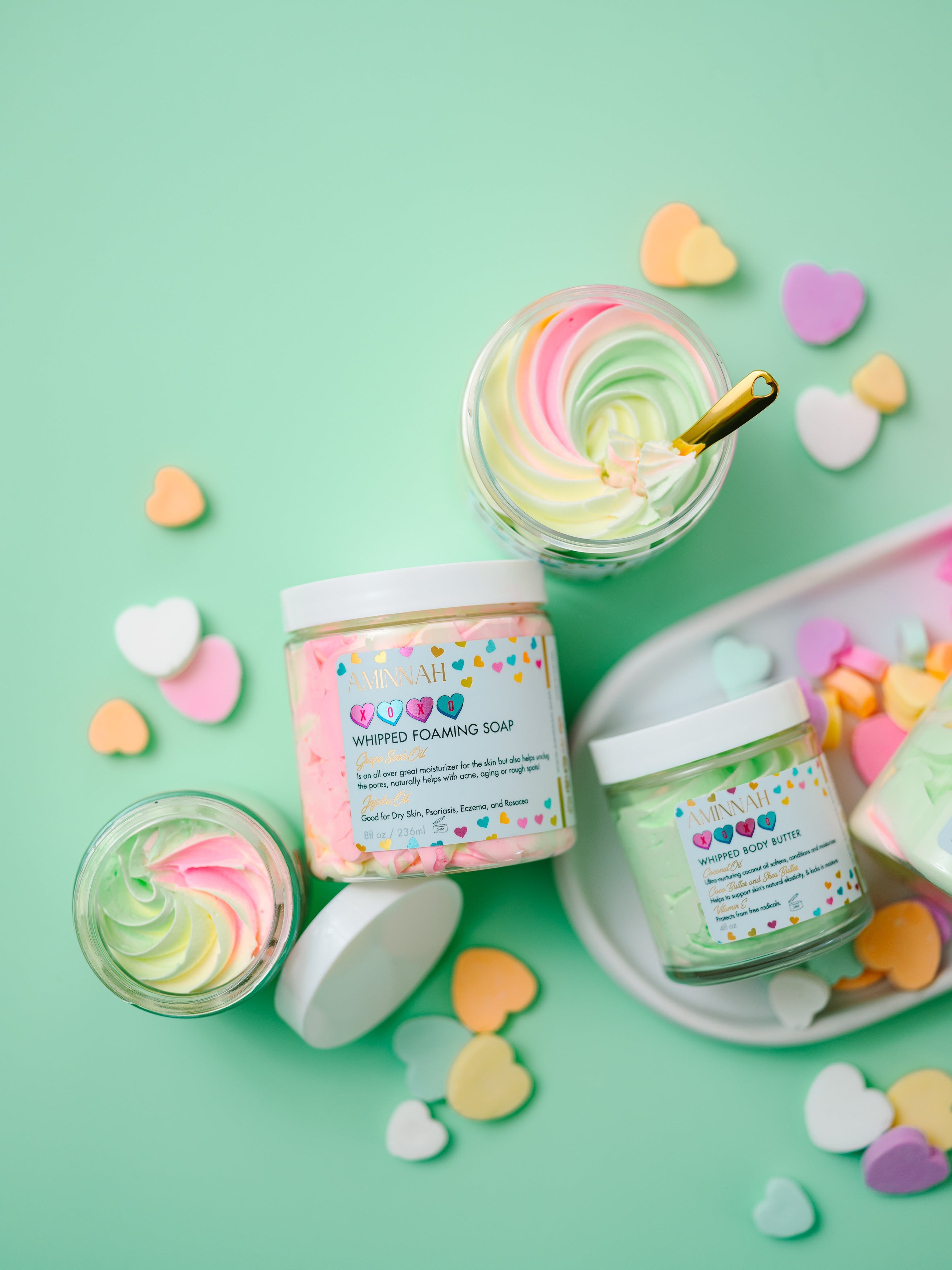 AMINNAH XOXO Whipped Body Butter with shea butter, cocoa butter, mango butter, coconut oil, jojoba oil, vitamin E, and fruit extracts. Sweet candy-scented vegan, cruelty-free clean beauty moisturizer from a female-owned brand for soft, hydrated, glowing skin.
