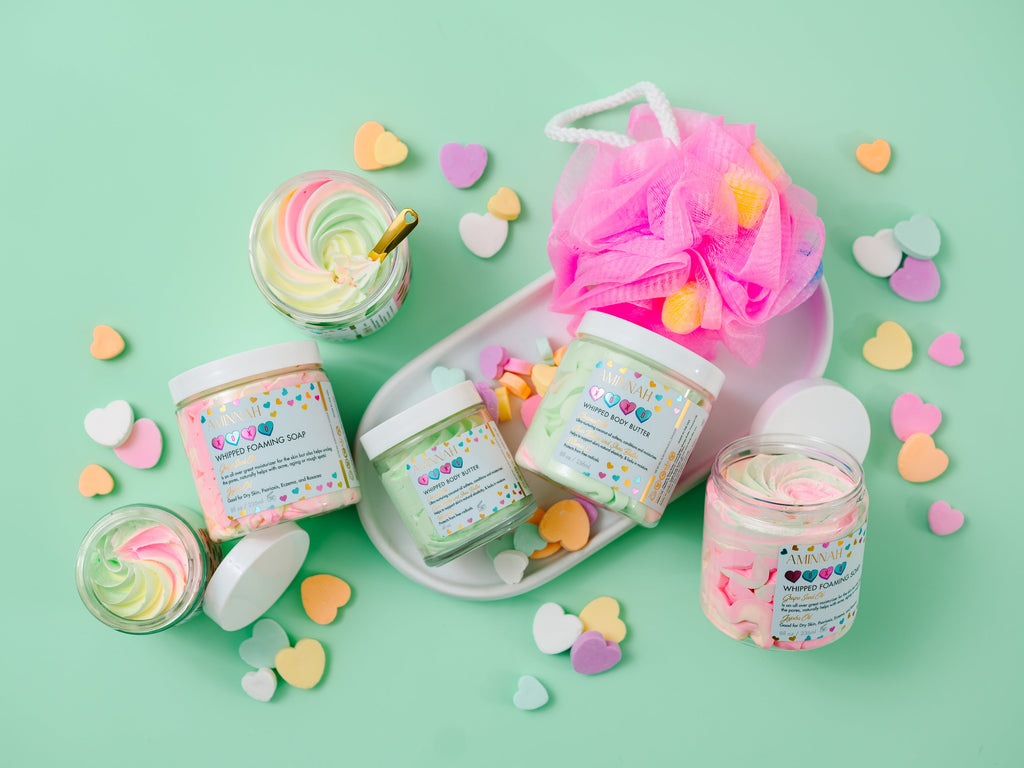 AMINNAH XOXO Whipped Body Butter with shea butter, cocoa butter, mango butter, coconut oil, jojoba oil, vitamin E, and fruit extracts. Sweet candy-scented vegan, cruelty-free clean beauty moisturizer from a female-owned brand for soft, hydrated, glowing skin.
