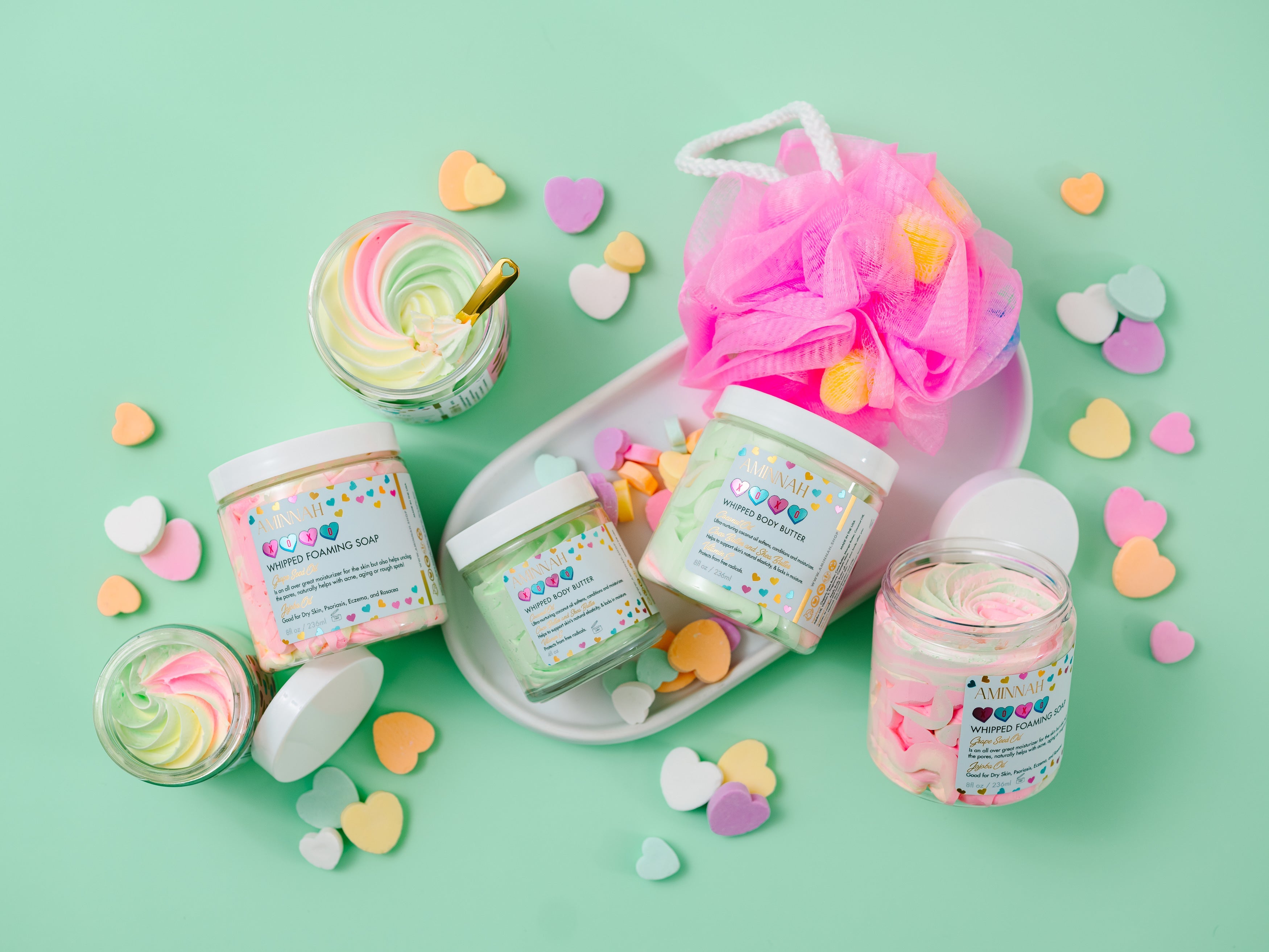 AMINNAH XOXO Whipped Body Butter with shea butter, cocoa butter, mango butter, coconut oil, jojoba oil, vitamin E, and fruit extracts. Sweet candy-scented vegan, cruelty-free clean beauty moisturizer from a female-owned brand for soft, hydrated, glowing skin.