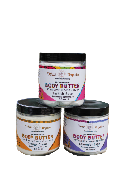 Three jars of Oshun Organics Aromatherapy Body Butter Intensive Moisturizer in Turkish Rose, Orange Cream, and Lavender Sage scents, rich moisturizing body butter skincare for soft, hydrated skin