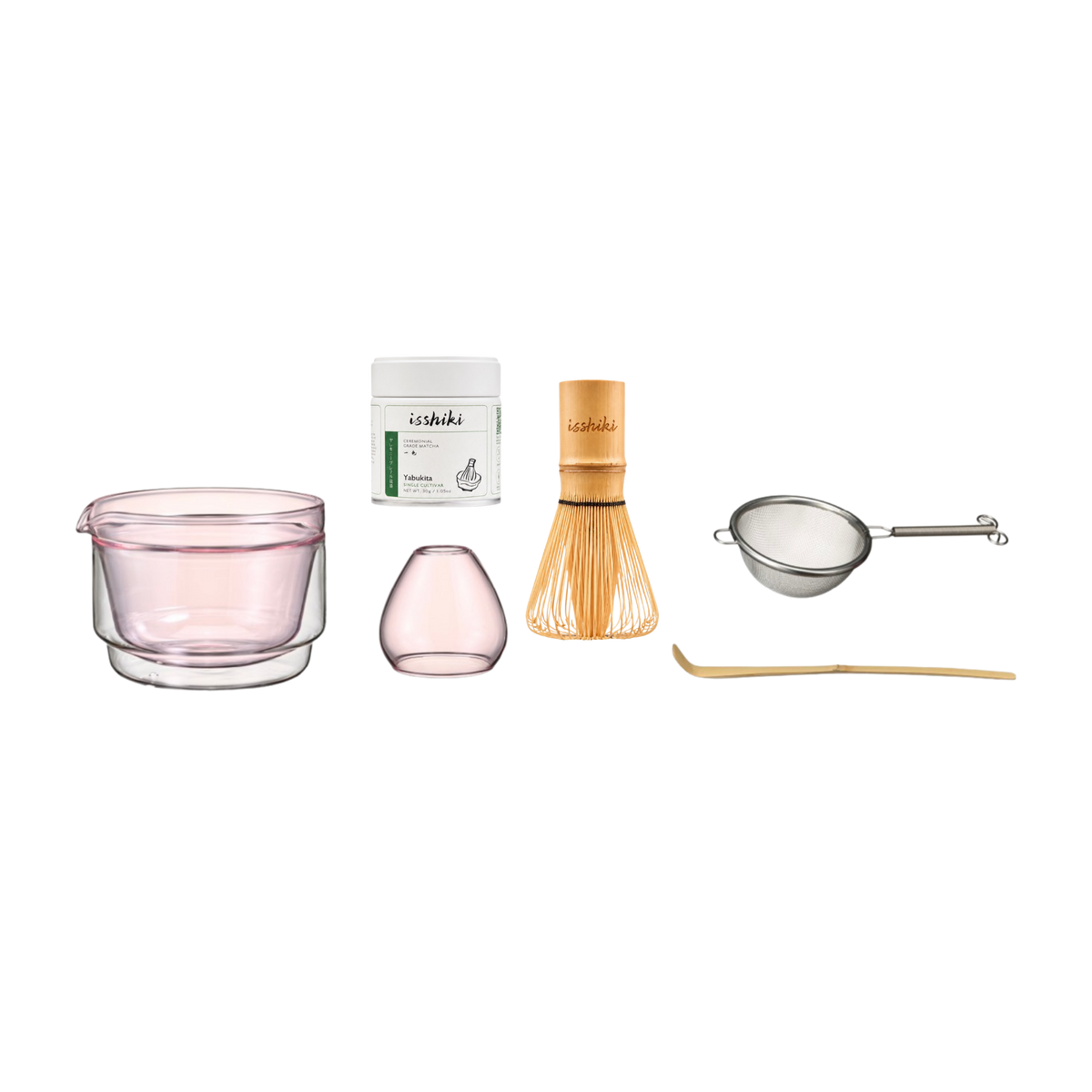 Set of tea-making tools including a pink glass, container, whisk, and other accessories on a white background.