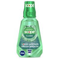 Scope mouthwash bottle with green liquid on a white background