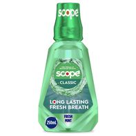 Scope mouthwash bottle with green liquid on a white background