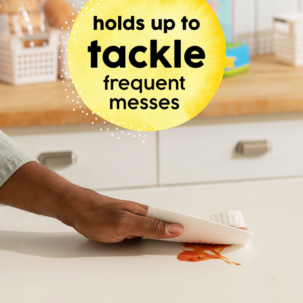 Person cleaning up a spill with text 'holds up to tackle frequent messes' on a yellow circle.