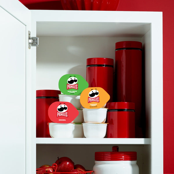 Pringles containers in a cabinet with red and white color scheme