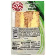 Packaged egg salad sandwich with a visible brand logo on a green background. Premo Sandwich