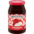 Jar of Smucker's strawberry jelly with a red lid on a white background
