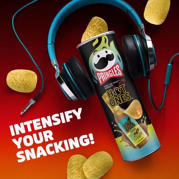 Pringles Hot Ones can with headphones and potato chips on a red and orange gradient background