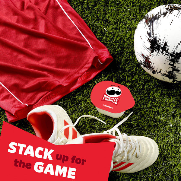 Red Pringles container with soccer gear on grass, featuring 'Stack up for the Game' text.