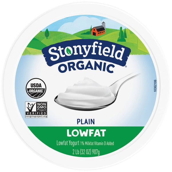 Stonyfield Organic plain lowfat yogurt container with a spoonful of yogurt on a white background