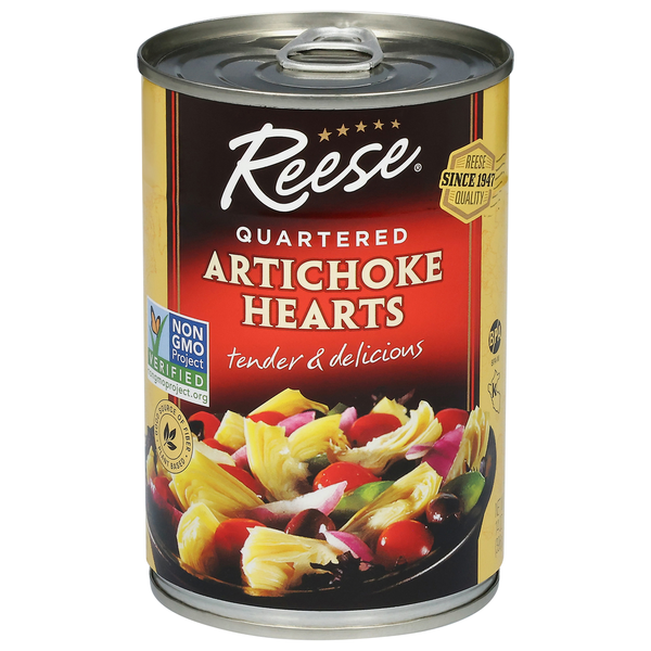 Can of Reese Artichoke Hearts with a colorful salad on a white background. NON GMO Project certified quartered artichoke hearts tender and delicious in a can. Reese quality company since 1947.