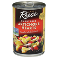 Can of Reese Artichoke Hearts with a colorful salad on a white background. NON GMO Project certified quartered artichoke hearts tender and delicious in a can. Reese quality company since 1947.