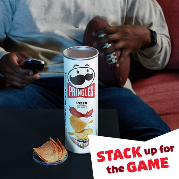 Person sitting on a couch with a Pringles can and chips, holding a football and phone, with 'Stack up for the Game' text overlay.
