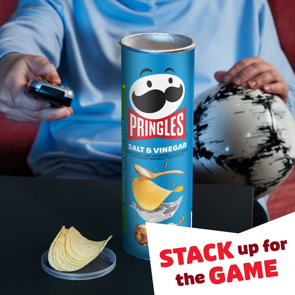 Pringles salt and vinegar can with a person watching TV in the background