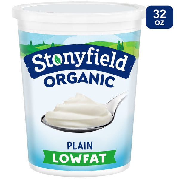 Stonyfield Organic plain lowfat yogurt container with a spoonful of yogurt on a white background