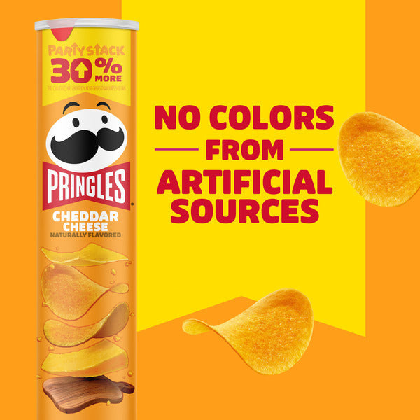 Pringles Cheddar Cheese flavor can with text about artificial colors on an orange background