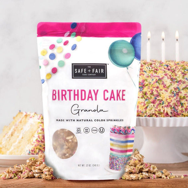 Safe + Fair Birthday Cake Granola package with colorful birthday sprinkles, gluten-free vegan granola made with ancient grains, nut-free allergy-friendly breakfast cereal, dairy-free soy-free non-GMO crunchy oat clusters, festive birthday cake flavor, healthy plant-based snack for yogurt, smoothie bowls, and breakfast.