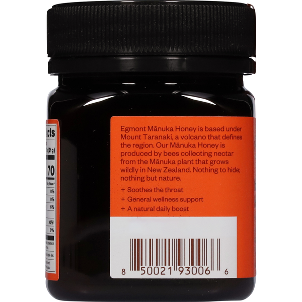 Back view of EGMONT New Zealand Intense Manuka Honey MGO 265+ UMF 10+ 8.8 oz (250 g) jar showing product information, wellness claims, barcode, and rear label on a raw, unpasteurized Manuka honey container. Egmont Manuka Honey is based under Mount Taranaki, a volcano that defines the region. Our Manuka Honey is produced by bees collecting nectar from the Manuka plant that grows wildly in New Zealand. Nothing to hide; nothing but nature.
