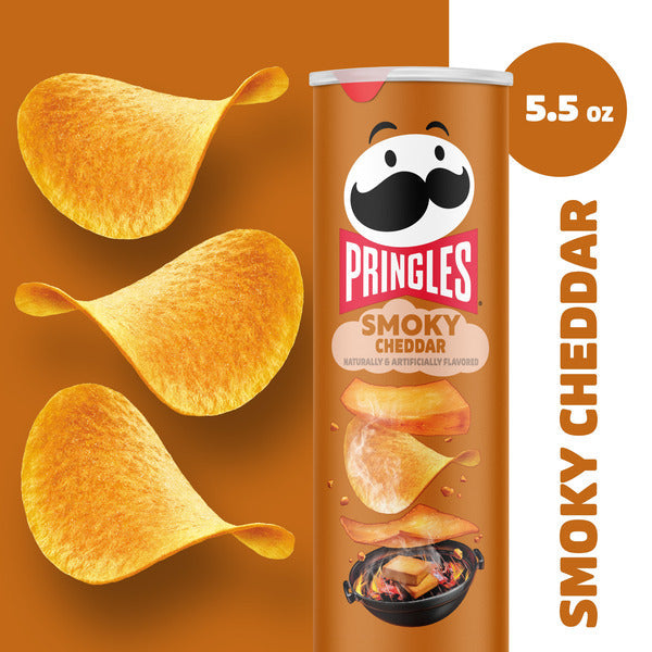 Pringles Smoky Cheddar potato chip can with chips on an orange background