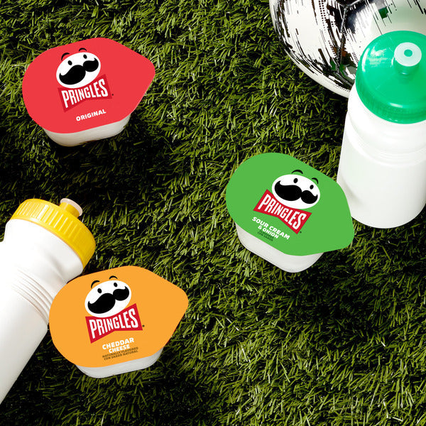 Pringles potato chip containers on a grassy surface